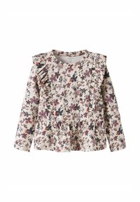 Blommig långärmad topp med volangdetaljer, gjord av mjukt tyg. Har en krämfärgad bakgrund med lila, rosa och marinblå blommönster.