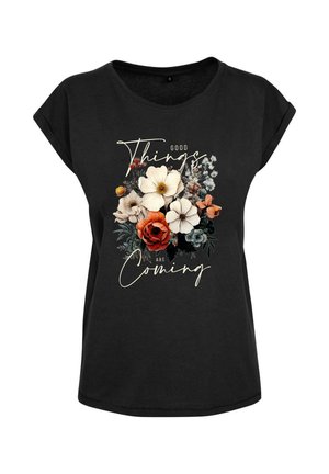 Schwarzes Baumwoll-T-Shirt mit kurzen, umgeschlagenen Ärmeln, das ein florales Design in Weiß, Orange und Grün zeigt, mit dem Text "Gute Dinge kommen."