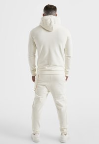 SIKSILK Teplákové kalhoty - off-white