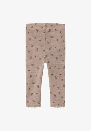 Leggings roses en tissu doux et texturé, présentant un motif floral marron et une délicate bordure en dentelle le long de l'ourlet.