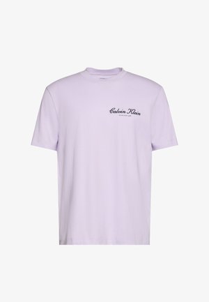 Lavender short-sleeve t-shirt with black "Calvin Klein Established 1968" text on left chest, crew neckline, plain design.
