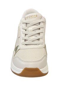 Sneaker atletica bianca con tomaia in pelle testurizzata, accenti dorati e suola in gomma. Presenta lacci piatti e dettagli perforati nella parte anteriore.