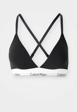 Zwarte triangulaire bh met dunne gekruiste bandjes en een witte elastische band met het Calvin Klein-logo.