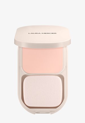 Kompaktowy puder w beżowej, zaokrąglonej kasecie. Zawiera jasnoróżowy puder i miękki, biały aplikator pod spodem. Nazwa marki na górze.