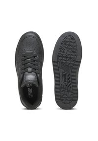 Baskets noires avec dessus en cuir lisse, perforations, bout rond et lacets plats. La semelle en caoutchouc présente un motif de traction texturé.