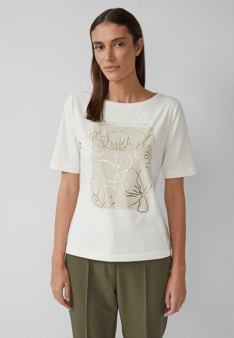 Kurzarm-Creme-T-Shirt mit einer goldenen Linienzeichnung von Blumen und dem Text "FOLLOW YOUR DREAMS." Weicher Baumwollmix.
