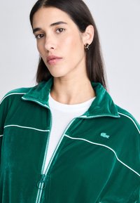 Lacoste Sweater met rits - fluorine foncé/white