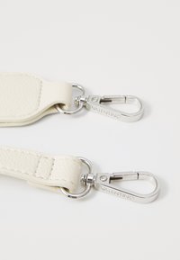 White textured leather strap with chrome hardware. Features two metal clips, one engraved with "VALENTINO." Simple, functional design.