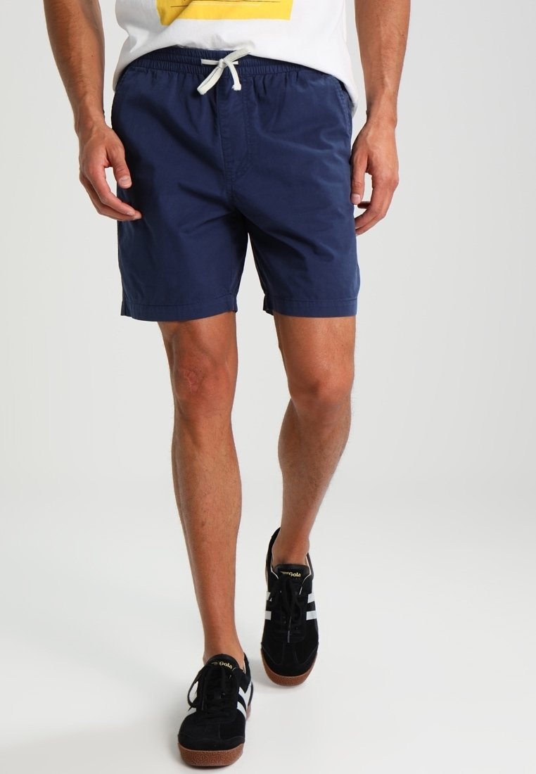 Shorts de bain bleu marine en tissu léger, dotés d'une taille élastique avec cordon de serrage. Design simple, longueur jusqu'aux genoux.