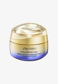 Krem do oczu Shiseido w zakrzywionym, złotym i niebieskim słoiczku. Posiada gładką, błyszczącą pokrywkę oraz etykietę z danymi o produkcie.
