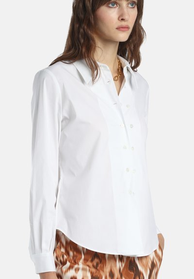 White button-up shirt made of smooth fabric, featuring a classic collar, long sleeves, and pearlescent buttons for closure.