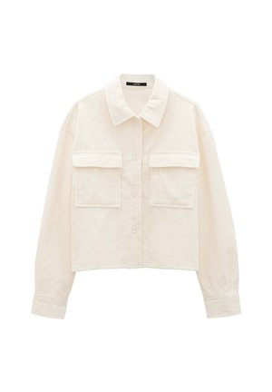 Cream corduroy cropped jacket with a classic collar, button closure, and two front pockets featuring a ribbed texture. Soft fabric finish.