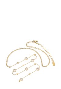 Collana in oro con dettagli in cristallo, con maglie testurizzate e pietre rotonde incastonate in cornici circolari. Chiusura con gancio e catena di prolunga.