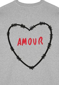 Felpa grigia con un contorno di cuore ricamato in nero cucito con filo spinato e la parola "AMOUR" in rosso.