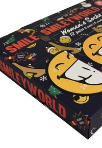Calendario dell'Avvento per donne con calze SmileyWorld, caratterizzato da uno sfondo blu scuro, vivaci grafiche di smiley gialli e design a tema natalizio.