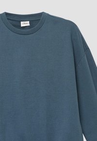 Blauwe katoenen sweatshirt met een ribbelboord en verlaagde schouders. Beschikt over een gladde textuur en subtiele stikdetails.