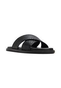 Sandali neri con fascia intrecciata sulle cinghie superiori, suola piatta e design open-toe. Finitura liscia con accenti minimi.