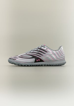 Gray and pink athletic shoe with black wavy stripes and a textured rubber sole, displayed in a side profile on a neutral background.