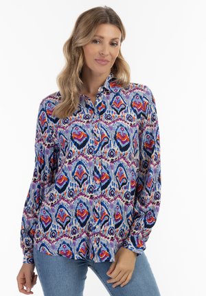 Camicia button-up realizzata in tessuto leggero con un motivo astratto multicolore che presenta tonalità di rosso, blu e viola; maniche lunghe.