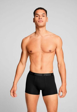 Black boxer briefs made of soft fabric, featuring a Puma logo on the elastic waistband, designed for a snug fit and comfort.