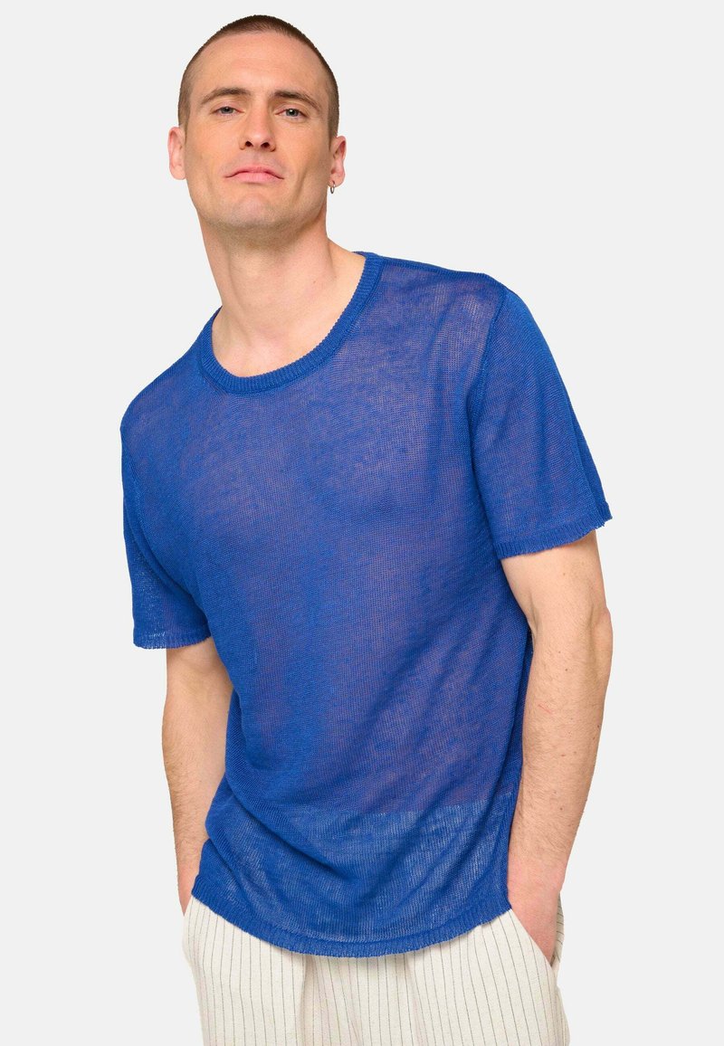 Blue, short-sleeve knit t-shirt with a round neckline and a sheer texture. Features a relaxed fit with raw hem details.