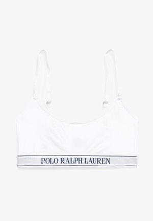 Balts kokvilnas topiņš ar regulējamām siksnām un tumši zilu logotipa joslu ar uzrakstu "POLO RALPH LAUREN" apakšā. Gluda tekstūra.