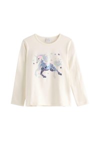 Hvid langærmet t-shirt med et funklende enhjørningsdesign udsmykket med multifarvede pailetter. Blødt bomuldsstof, rund hals.