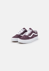 Sneaker in suede viola con lacci bianchi e una striscia bianca laterale, caratterizzati da un design low-top e suola in gomma.