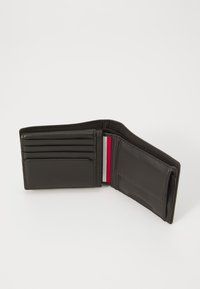 Black leather wallet with multiple card slots, a red and white accent stripe, and a transparent ID slot. Compact, bi-fold design.