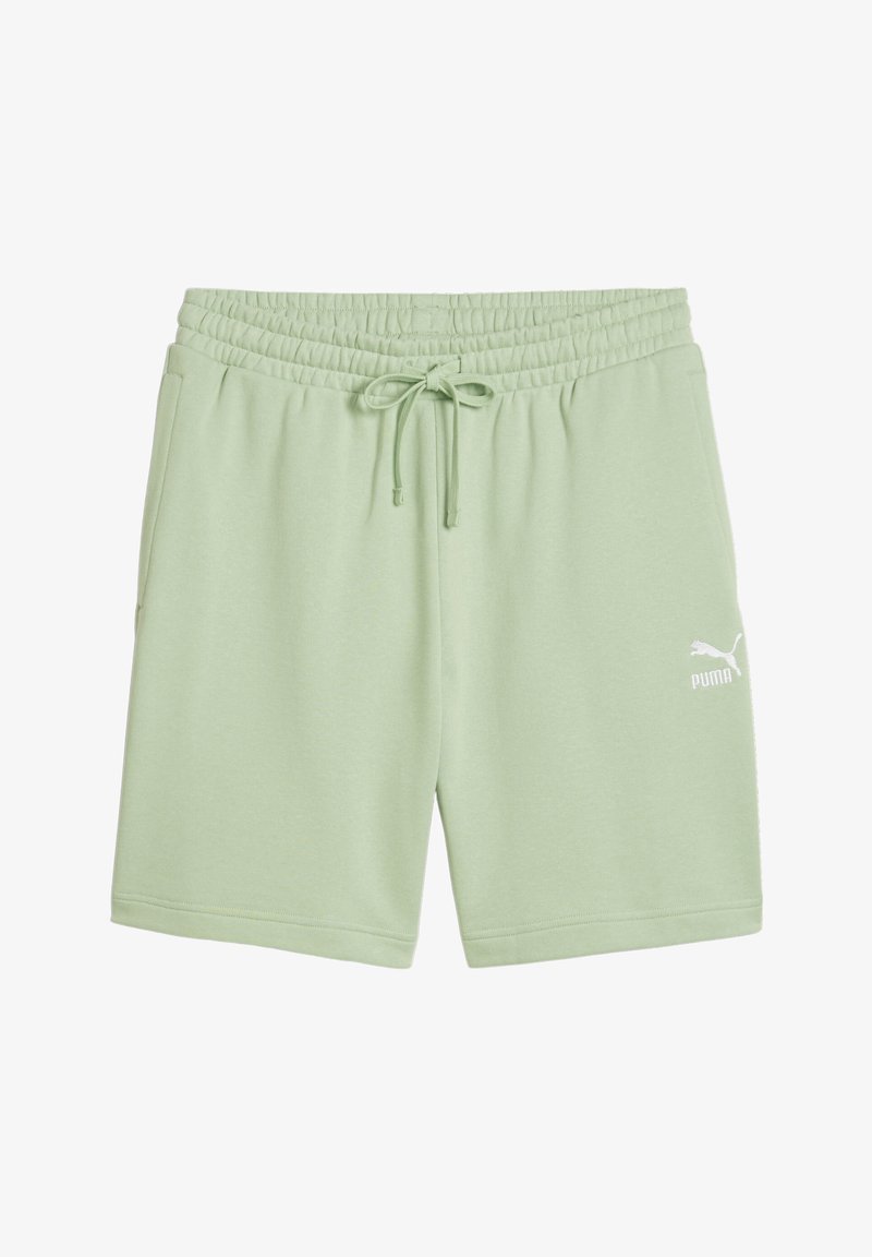 Helle grüne Baumwollshorts mit elastischem Bund und Kordelzug, versehen mit einem weißen Puma-Logo auf der unteren rechten Seite.