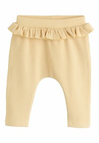 Leggings à rayures, de couleur jaune clair, avec un volant à la taille, dotés d'une taille élastique et de jambes fuselées.