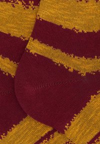 Calze a righe color granata e giallo con una morbida trama a maglia, caratterizzate da strisce orizzontali e aree rinforzate su punta e tallone.