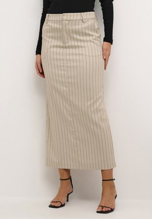 Beige striped midi skirt with a straight cut, featuring side pockets and a smooth fabric texture. Worn with black strappy high heels.