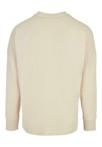Hellbeige Langarmshirt mit Rundhalsausschnitt und Bündchen. Hergestellt aus weichem Stoff, zeichnet es sich durch eine glatte Textur und ein einfaches Design aus.