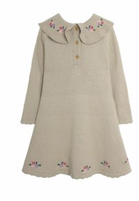 Beige gebreide jurk met een kraag, drie knopen en bloemendecoraties op de kraag en de zoom. Lange mouwen met golfrand.