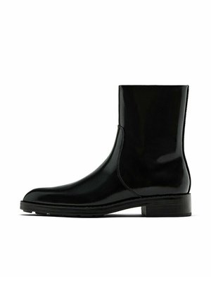 Bottine en cuir noir poli avec petit talon, bout arrondi et détail de couture latérale, vue de profil sur fond blanc.
