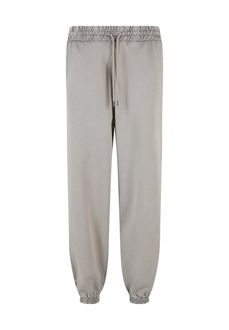 Lysegrå joggers lavet af blødt stof, med en elastisk talje med snor og elastiske manchetter ved anklerne.