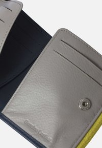 Leather wallet featuring a gray interior, navy accents, multiple card slots, and a silver snap closure. Textured leather with smooth finish.