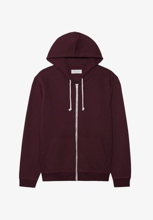 Burgunderfarget hettegenser med glidelås, snorhette, frontlommer og ribbede mansjetter. Laget av et mykt, teksturert materiale.