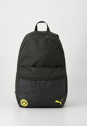 Black fabric backpack with a textured lower section, featuring a yellow BVB logo and a small yellow Puma logo. Two compartments with zippers.