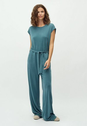 Teal jumpsuit with a relaxed fit, cap sleeves, wide legs, and a matching tie belt. Material appears soft and drapes smoothly.
