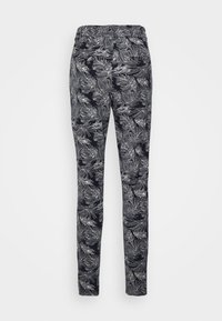 Calças pretas com um padrão de folhas brancas, cintura elástica, corte justo e textura de tecido suave, adequadas para uso casual.