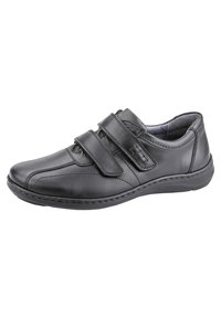 Black leather shoe with two Velcro straps, rounded toe, stitched detailing, and cushioned sole for comfort. Designed for easy wear.