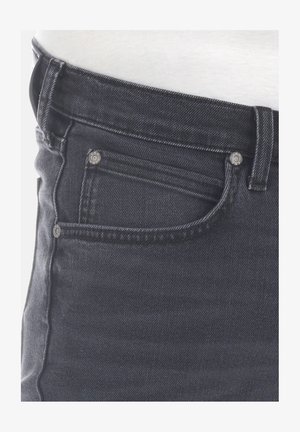 Dunkelblaue Jeans aus Denim mit glatter Textur, sichtbaren Nähten und einer Vordertasche. Verfügt über zwei Metallnieten und ein klassisches Taillendesign.