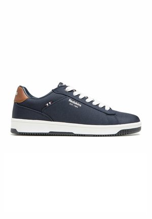 Zapatillas azul marino con parte superior de tela texturizada, cordones blancos, detalles de piel marrón en el talón y suela de goma blanca con agarre.