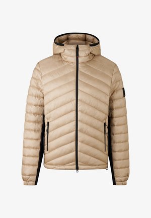 Veste en duvet beige zippée avec un col haut, des accents noirs et un motif piqué en chevrons. Dotée de deux poches latérales et de poignets élastiques.