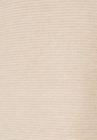 Beige textiel met een fijne ribbelstructuur. Gelijkmatige kleurverdeling met een zachte glans, geschikt voor verschillende toepassingen.