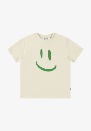 Tricou din bumbac de culoare crem, cu un grafic mare al unei fețe zâmbitoare verzi pe partea din față. Mâneci scurte și decolteu rotund.