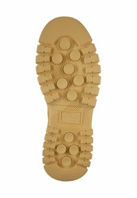 Gumowa podeszwa w jasnym kolorze tan z teksturowaną powierzchnią, z okrągłymi i pionowymi wzorami bieżnika, zapewniającymi lepszą przyczepność i stabilność.