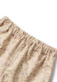 Pantalons à motif floral avec une taille élastique, présentant une palette de couleurs pastel douces de rose, beige et vert, fabriqués à partir d'un tissu léger.